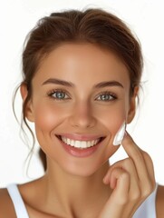 Naklejka premium Smiling woman applying face cream, promoting skincare routine, glowing complexion, youthful look, healthy skin, beauty care.