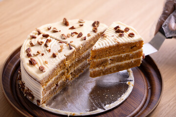Delicious Slice of Carrot Cake with Cream Cheese Frosting. A mouth-watering close-up of a slice of carrot cake with rich cream cheese frosting. The cake is beautifully layered with moist, carrot