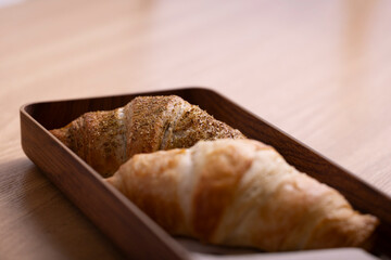 A delicious Zaatar croissant, showcasing its flaky, golden-brown crust sprinkled with aromatic zaatar seasoning. Perfectly baked, this Middle Eastern twist on a classic pastry offers a unique flavor