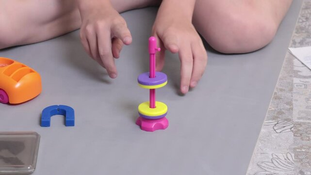Teenage girl conducts an experience with magnet. Science and education. Tools for learning. 