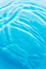 Obraz premium Macro blue water surface,drops on water with circles on a blue background close up