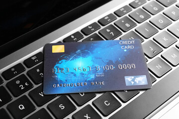 One plastic credit card on modern laptop