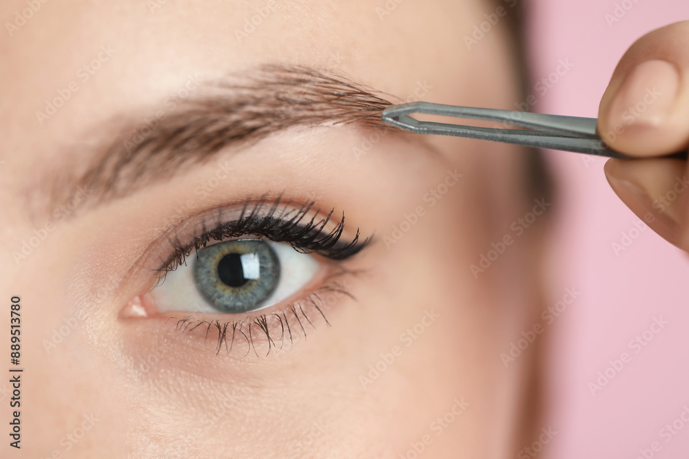 Sticker young woman plucking eyebrow with tweezers on pink background, closeup