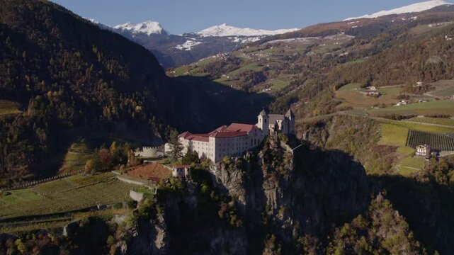 Aerial view of Monastery in Dolomites with mountain peaks in autumn, Chiusa, Italy.