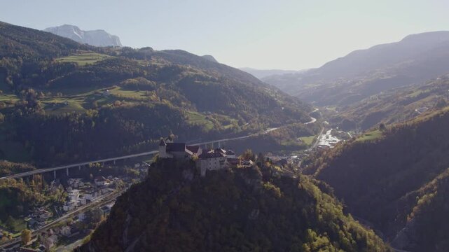 Aerial view of Monastero di Sabiona monastery surrounded by Dolomite peaks in autumn, Chiusa, South Tyrol, Italy.