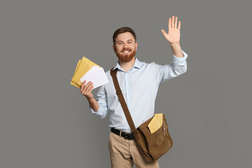 Postman with brown bag delivering letters on grey background