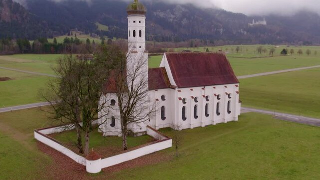 Aerial view of St. Coloman church in cloudy Bavaria, Germany.