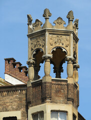 Revival Neogothic architecture in the historic city center of Turin. Top detal of corner crown tower. Italy. 