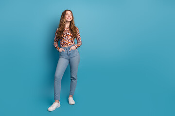 Full length portrait of nice young girl look empty space wear top isolated on blue color background