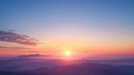 Fototapeta premium Beautiful sunrise over misty mountains with vibrant colors of dawn, the natural beauty and tranquility of nature.