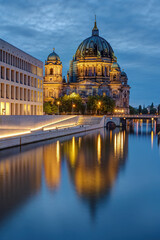 Fototapeta premium The modern backside of the City Palace, the cathedral and the river Spree in Berlin at dusk