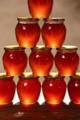 Jars of fresh flower honey on the table