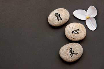 Top view of Chinese character representing body, mind and spirit text engraved on zen stones