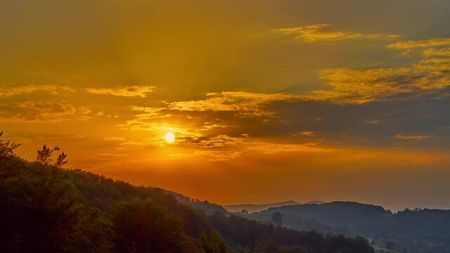 Nature landscape sunset cumulus clouds rolling over hills and mountains time-lapse