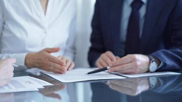 Business people having meeting discussing contract details. Diverse group team, close up