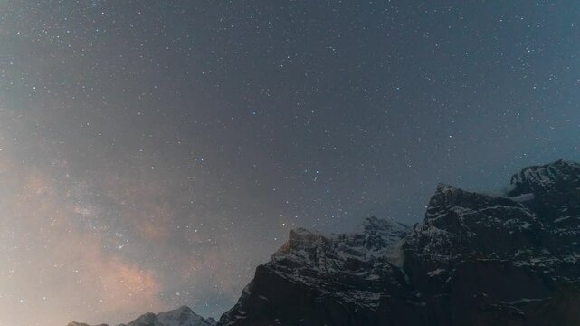 4K Night Lapse shot of Milky way galaxy rising above the snowy Himalayan mountain peak as seen from Khangsar Village in Lahaul and Spiti district, Himachal Pradesh, India. Milkyway above the Himalayas