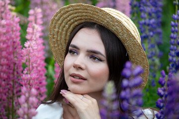 Portrait of a girl wearing a straw hat in lupine colors