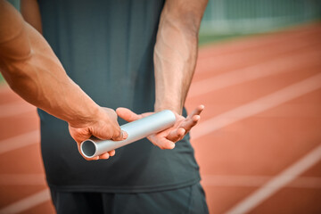 Baton, fitness and athletes on track for race in stadium for running relay marathon in competition....