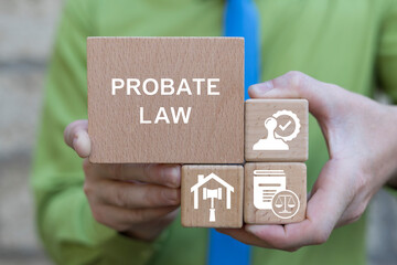 Lawyer holding wooden blocks with icons sees inscription: PROBATE LAW. Concept of probate law....