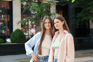 Portrait of two beautiful twin sisters outdoors