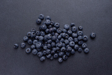 blueberries are scattered on a blue background