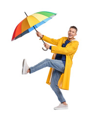 Young man with rainbow umbrella on white background © New Africa