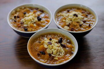 Three bowls of traditional Ashura dessert or Noah's Pudding