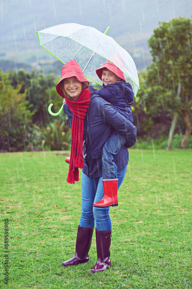 Poster Playful in the rain. Cropped portrait of a mother carrying her son on her back outside in the rain.