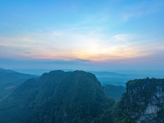 Aerial view above the mountain in tropical rainforest and beautiful sunrise scenery view in Phang Nga valley.scenery sunrise above the mist