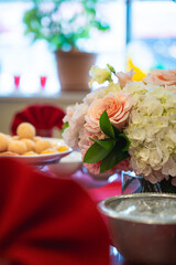 A bouquet of pastel flowers for summer sits in the middle of a table at a Chinese restaurant.