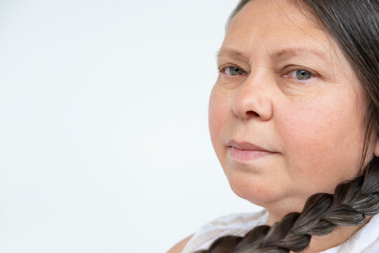 happy mature woman, being braided long brown hair, enjoying moment self-care, self-acceptance and journey aging with grace and dignity