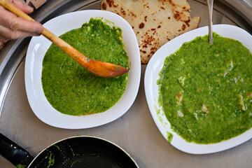 Nettle soup eaten with a wooden spoon. organic nettle dish. Turkish meal.