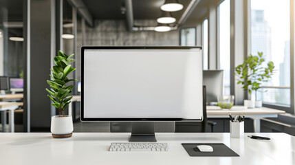 A computer monitor sits on a desk in a room with a potted plant and a keyboard