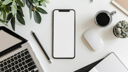 A white iPhone sits on a desk next to a laptop and a mouse