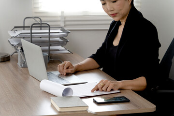 senior businesswoman is pressing the key board on a laptop. Computers