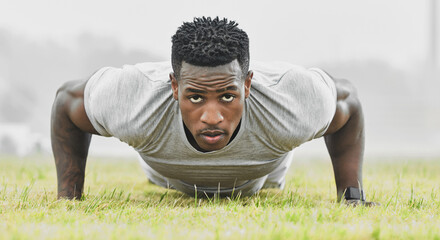 Black man, portrait and push up outdoor for fitness, wellness and health goals challenge in morning. Male athlete, face and exercise on field for workout, training and performance with strong muscle