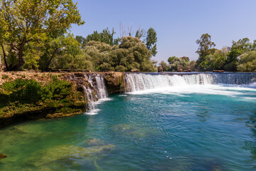 Fototapeta premium Landscape with trees, river and rocks. Manavgat Waterfall in Turkey.