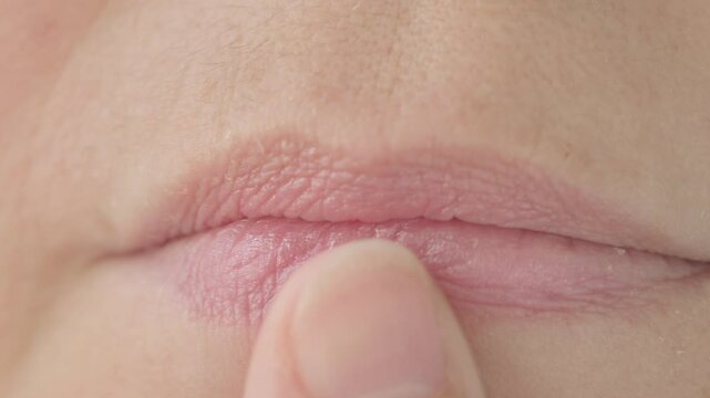 close up lips mature female face, woman 50 years old carefully examines wrinkles around mouth, skin defects, facial hair, age-related changes, aesthetic cosmetology, anti-aging procedures