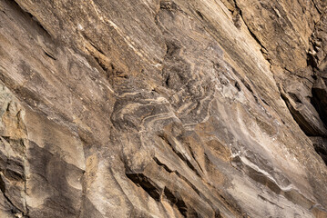 Strata of foliated homogeneous metamorphic rock derived from sedimentary rock.They  form from tectonic processes as continental collisions, which cause horizontal pressure, friction and distortion.