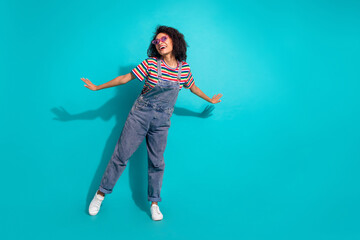 Photo of positive cheerful girl moving hands look profile side isolated blue color background