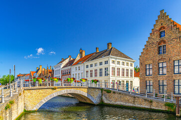 Bruges cityscape, Sint-Annareibrug stone Bridge, Sint Annarei water canal of Reie river, medieval buildings in Bruges city historic centre, embankment in Brugge old town, Flemish Region, Belgium