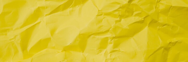 Bright crumpled yellow paper texture, useful for backgrounds, crafting projects, or festive celebrations like Easter and Spring decor