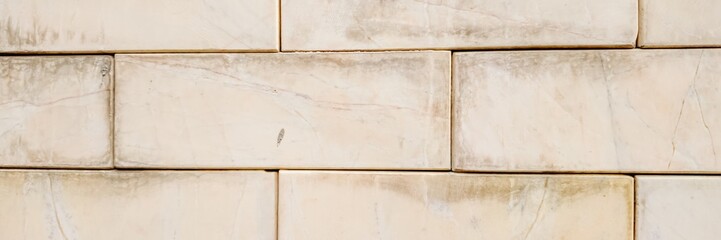 Close-up of a weathered white brick wall emphasizing aging architecture and rustic building materials