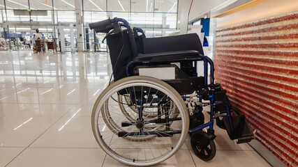 Wheelchair parked in a modern airport terminal, highlighting accessibility challenges and travel assistance for individuals with disabilities