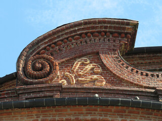 Carignano Palace. Detail of brick pediment decorated with volute. Historic city center of Turin. Piedmont. Italy.