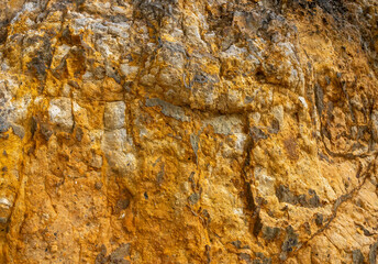 Deep yellow sulfur rock in a hot spring at the edge of Yanshamigan park, Beitou, Taipei, Taiwan