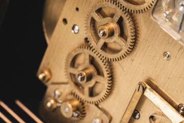 Cogwheels of a vintage clock, close-up photo