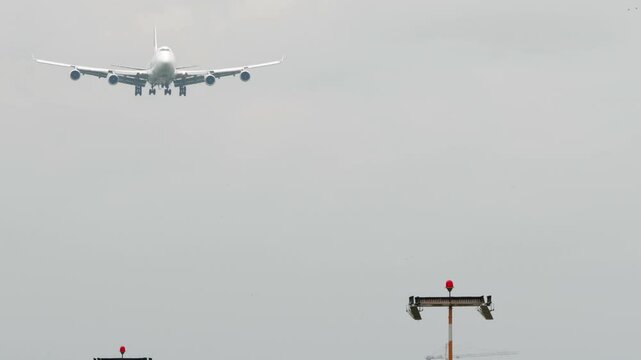 Huge double-deck four-engine airliner landing. Airliner descending. Airplane approaching