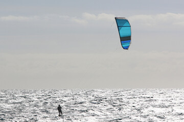 Kitesurfer riding his board in waves	
