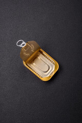 Metal aluminum opened can of canned sardines in oil with spices and salt